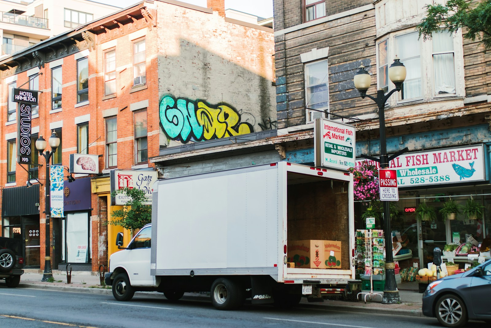 A box truck making a delivery on a city street