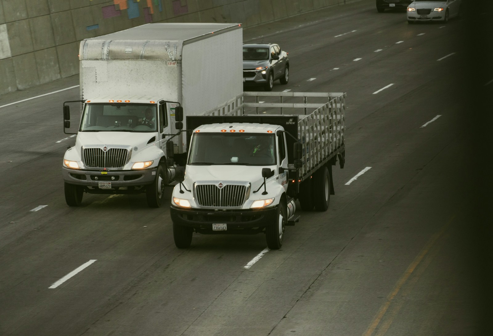 Two work trucks on a highway